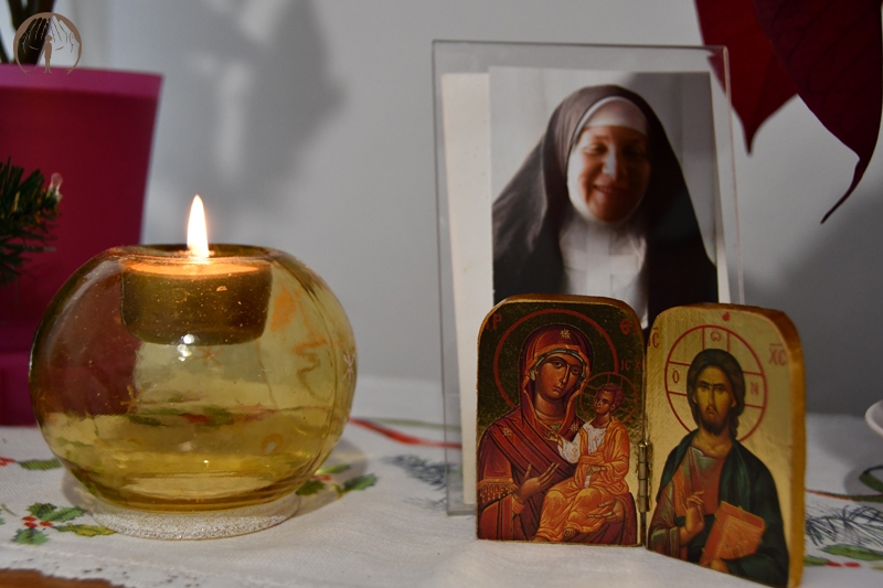 Ołtarzyk kolędowy, obrazek Matki Bożej z Dzieciątkiem Jezus na rękach, obraz bł. Matki Elżbiety, zapalona świeca 